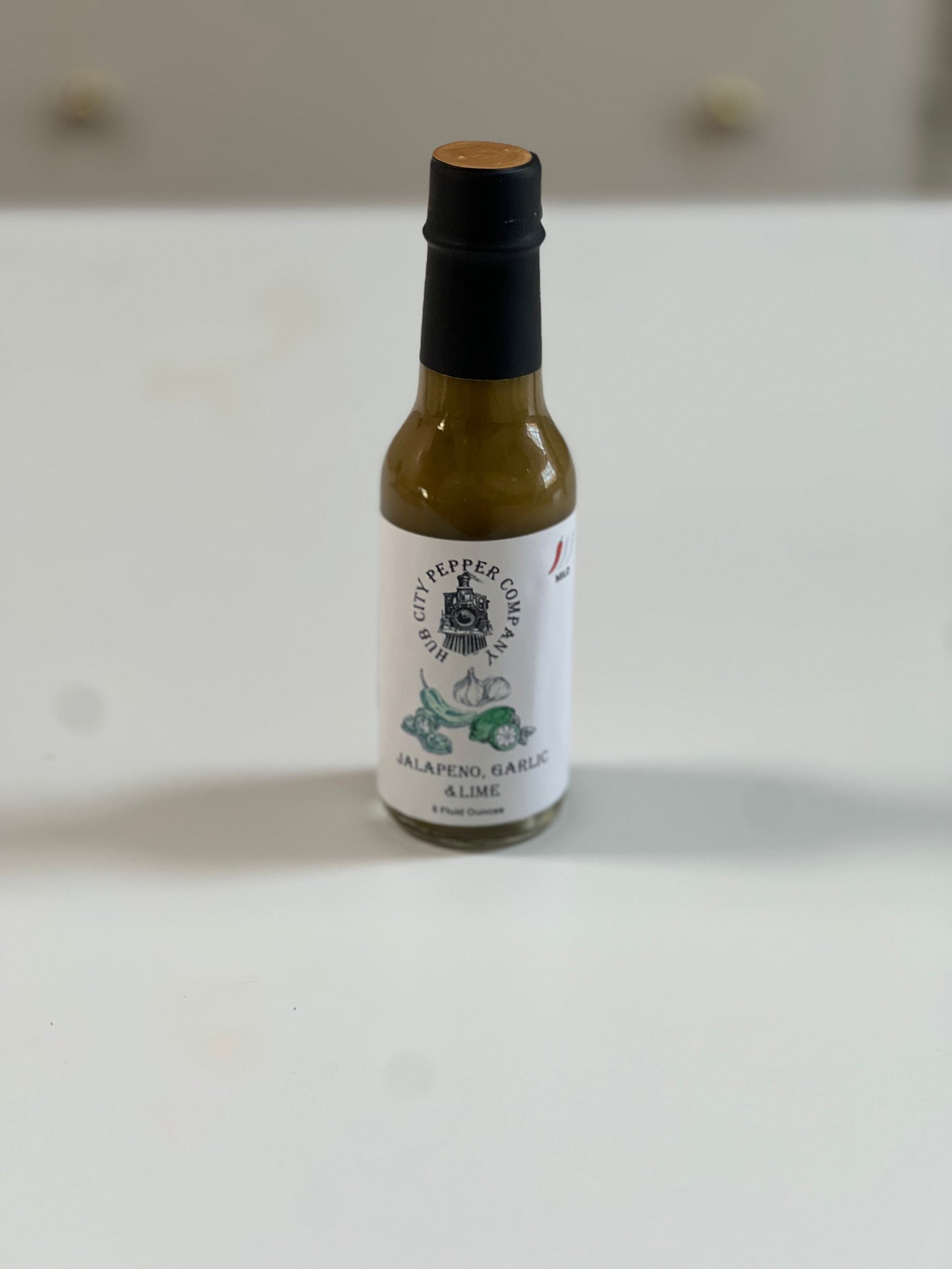 Jalapeno, Garlic and Lime Hot Sauce Front View from distance