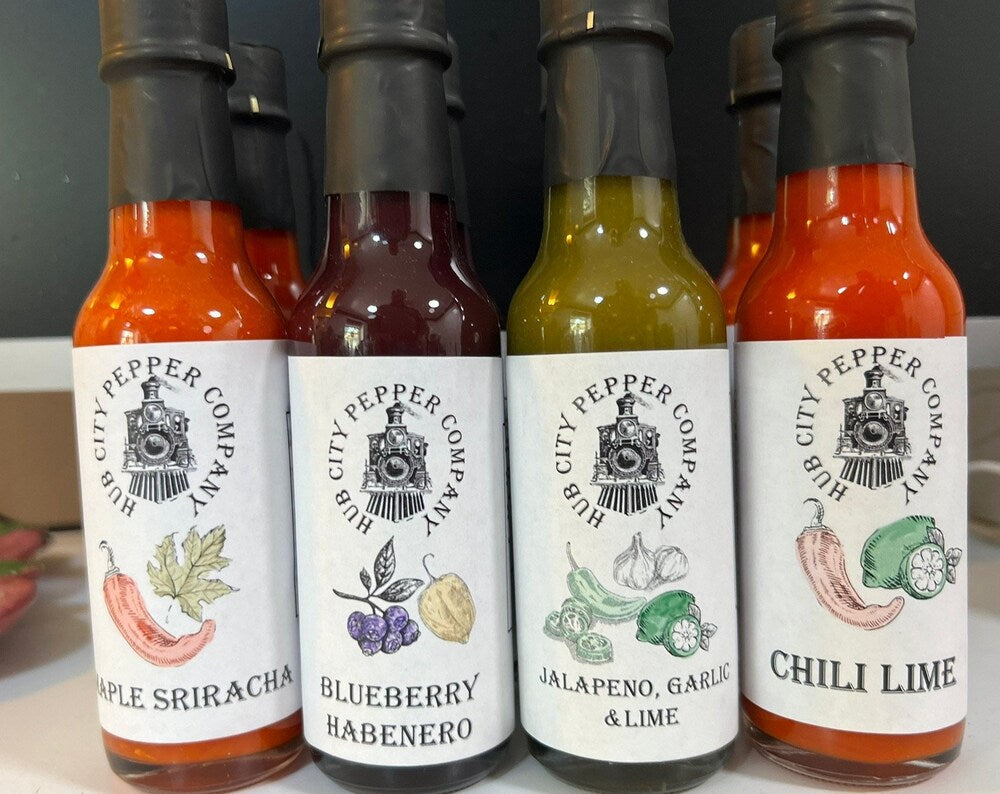 4 Pack of hot sauce flavors. Including Maple Sriracha, Pickle and Roasted Poblano, Blueberry Habenero and Chili Lime flavors. all images are from the front and close up. 